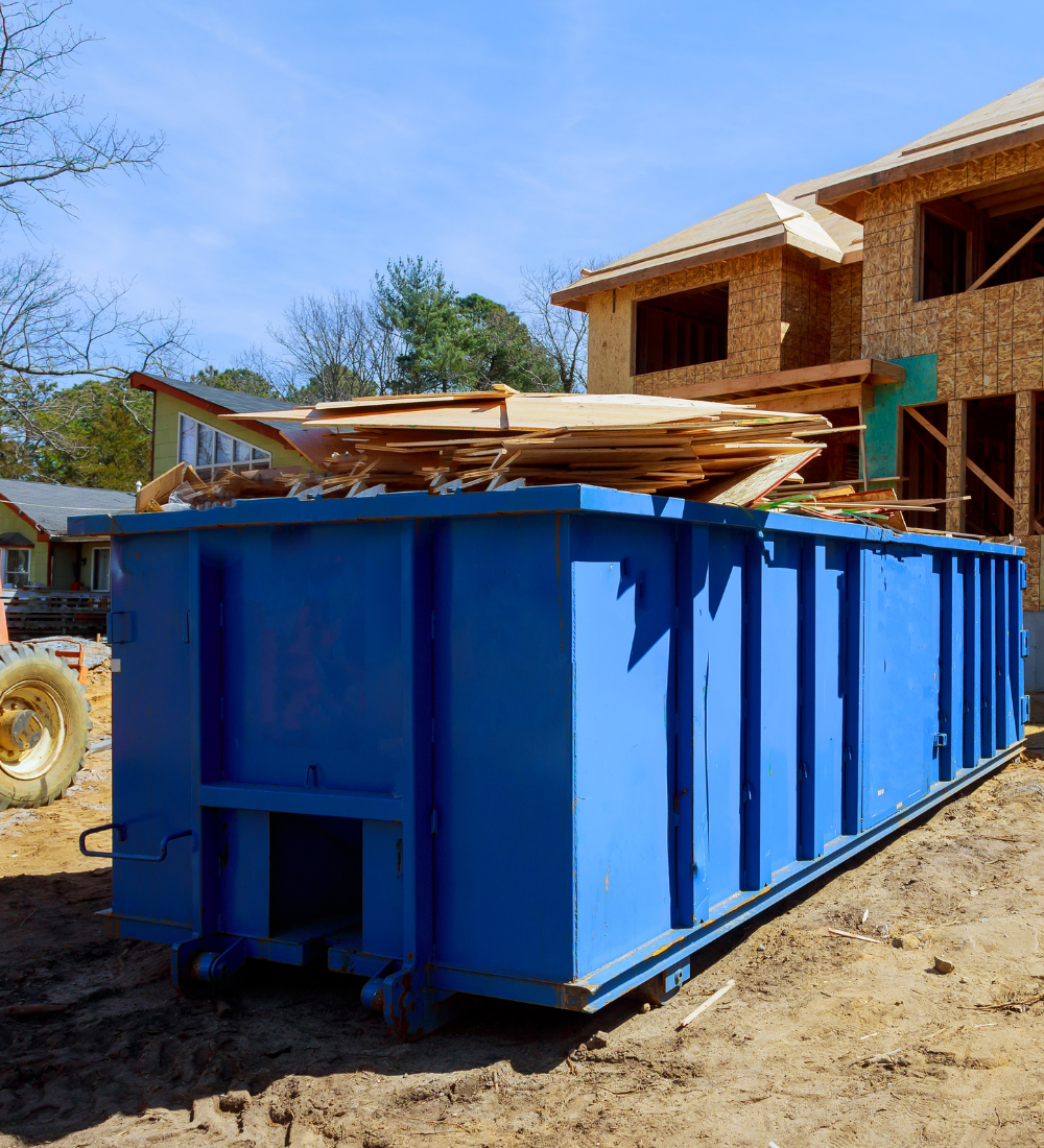 professional blue dumpster rental being used
